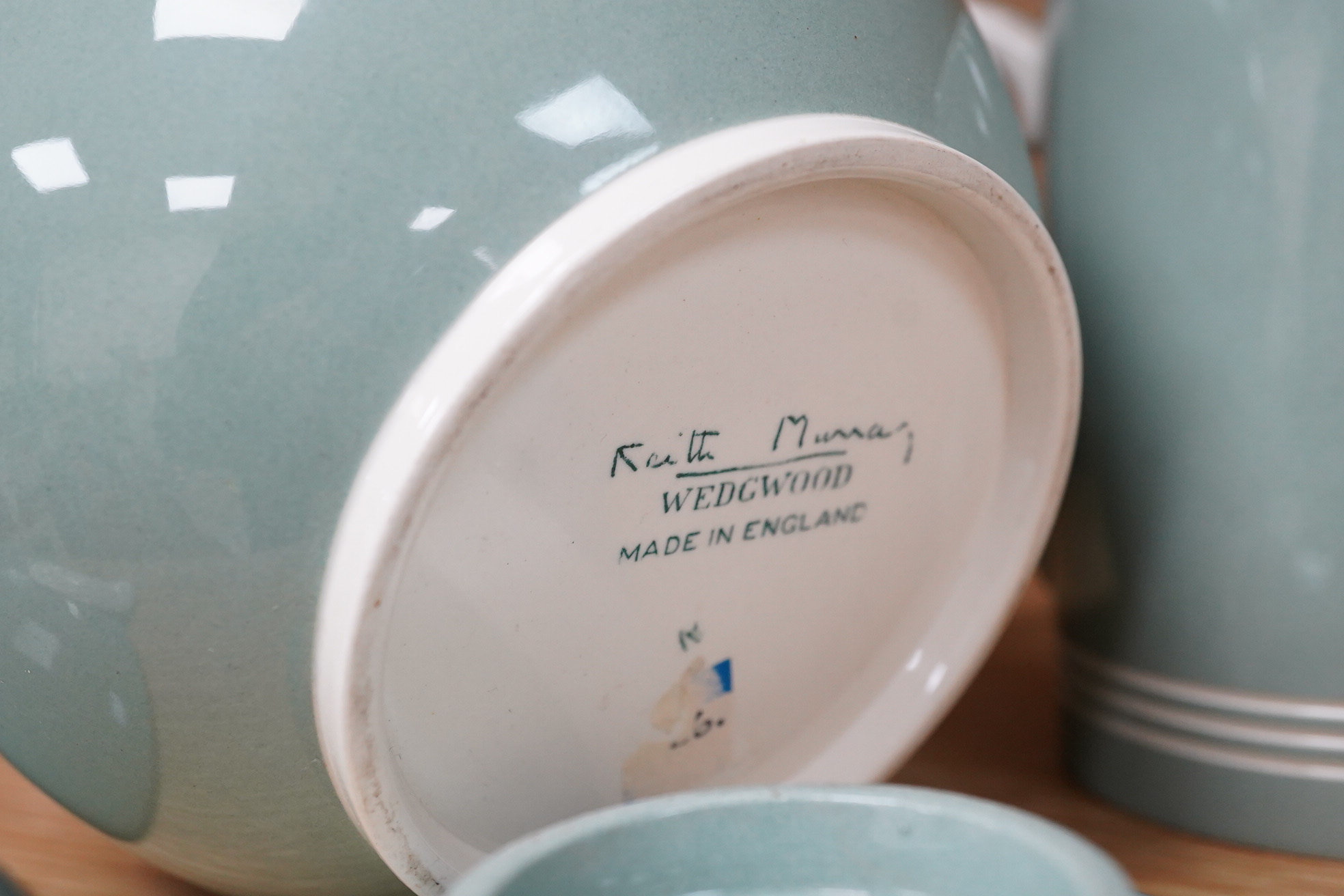 Keith Murray for Wedgwood - a celadon mug, two handled vase and two tazzas, tallest 13cm